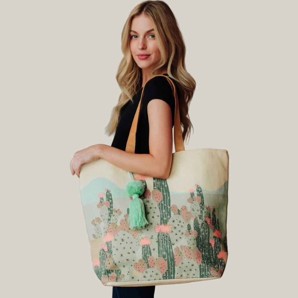 Woman holding a tote bag with cactus design indoors