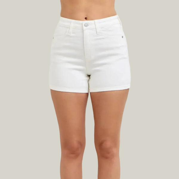White denim shorts worn by a person on a plain background