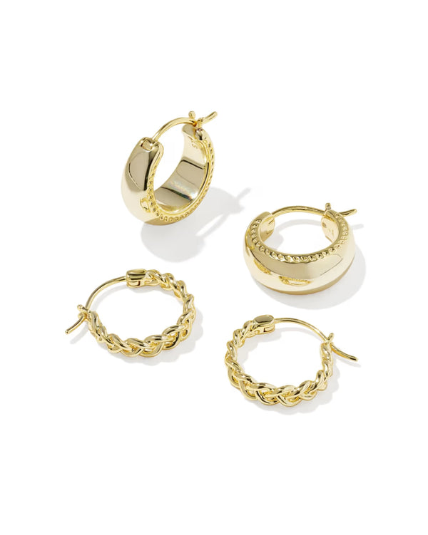 Set of gold hoop earrings on a white background