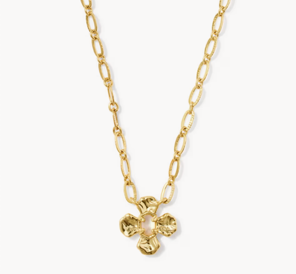 A gold chain necklace featuring a textured, four-petal flower pendant, displayed against a clean white background.