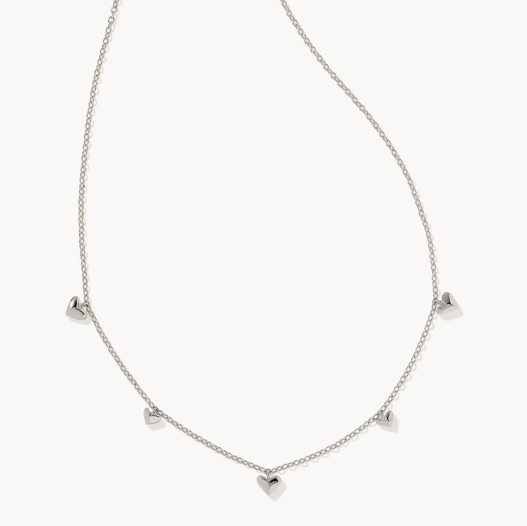 Silver necklace with heart-shaped pendants on a white background
