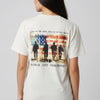 Person wearing a white t-shirt with a graphic design on the back featuring an American flag and silhouettes of soldiers.