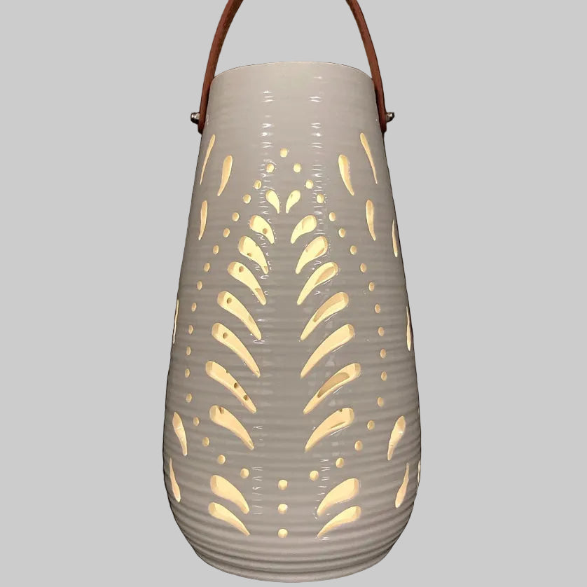 Decorative lantern with cut-out patterns on a gray background