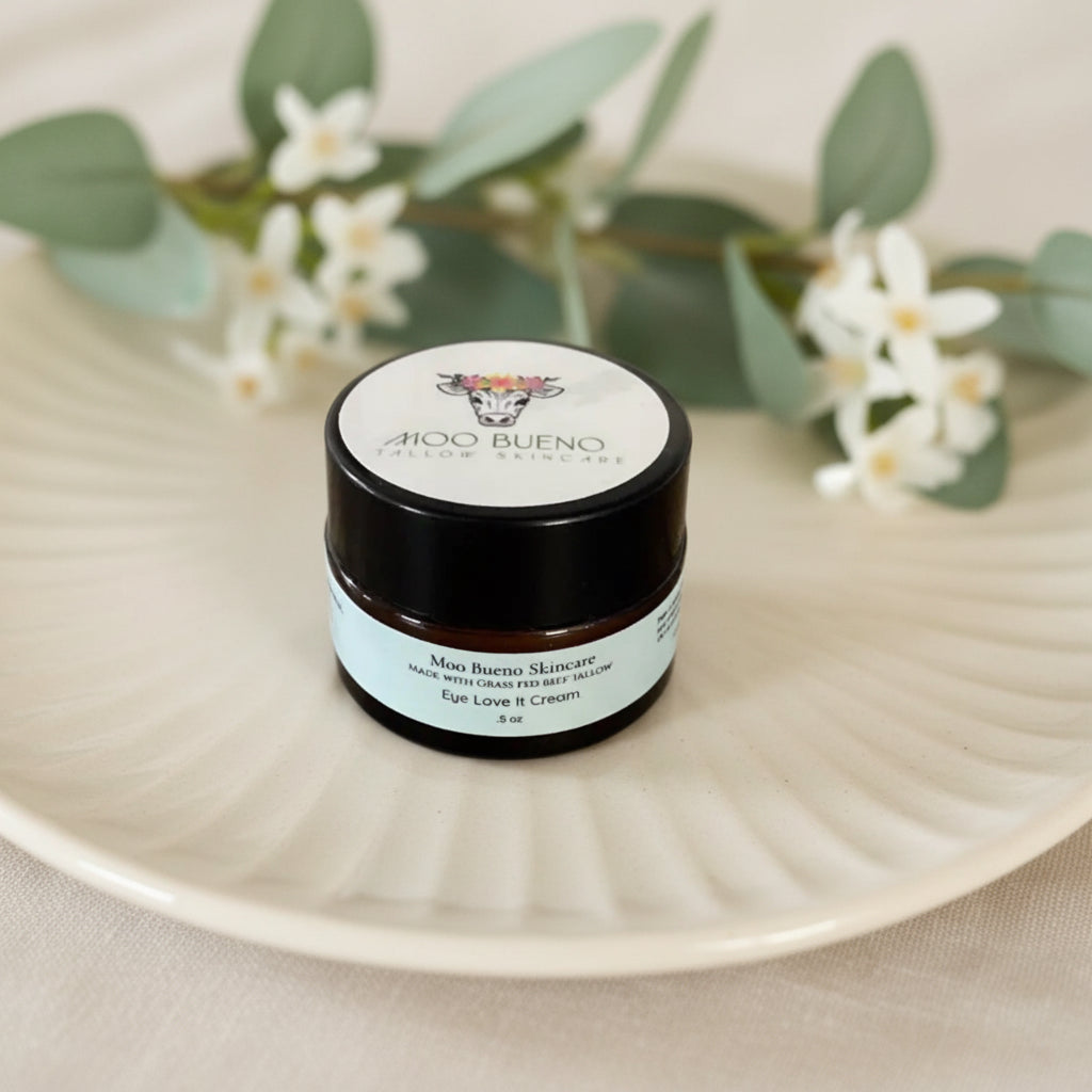 Jar of Moöo Bueno skincare cream on a plate with flowers