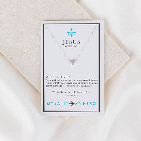 Necklace card with 'Jesus Loves You' message on a white background
