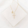 Gold cross necklace on a white background