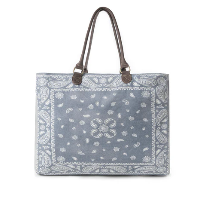 Blue patterned tote bag with brown handles on a white background