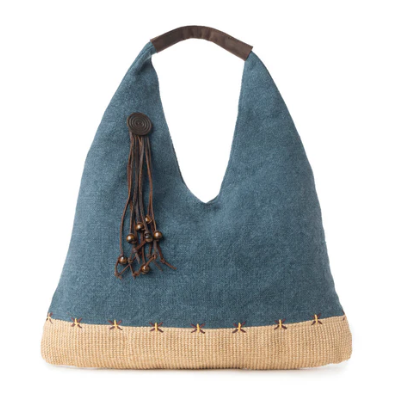 Blue handbag with a woven base and decorative tassel on a white background