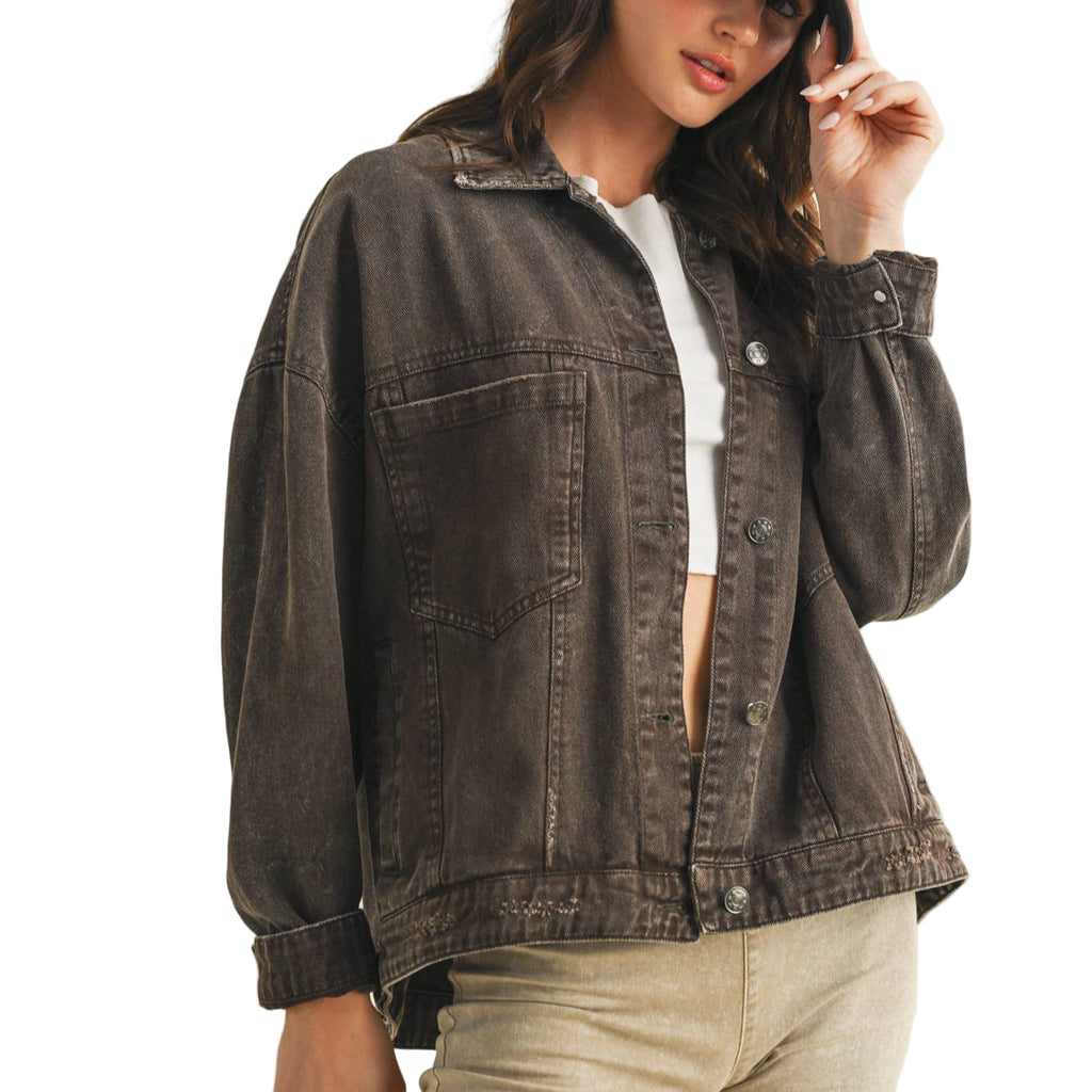 Woman wearing a brown denim jacket on a white background