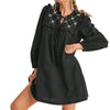 Black dress with ruffled neckline and long sleeves on a white background
