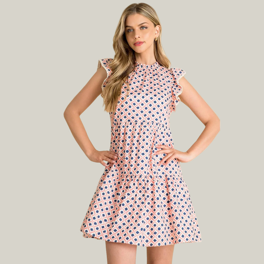 Woman wearing a patterned dress against a beige background