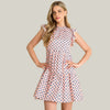 Woman wearing a patterned dress against a beige background