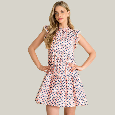 Woman wearing a patterned dress against a beige background