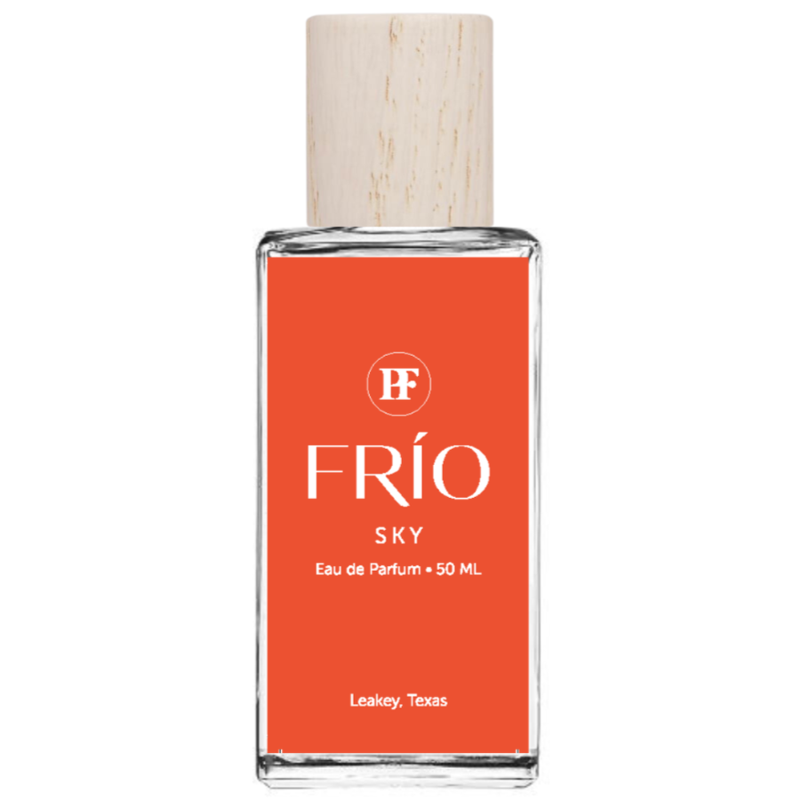 Perfume bottle with orange label and wooden cap on white background