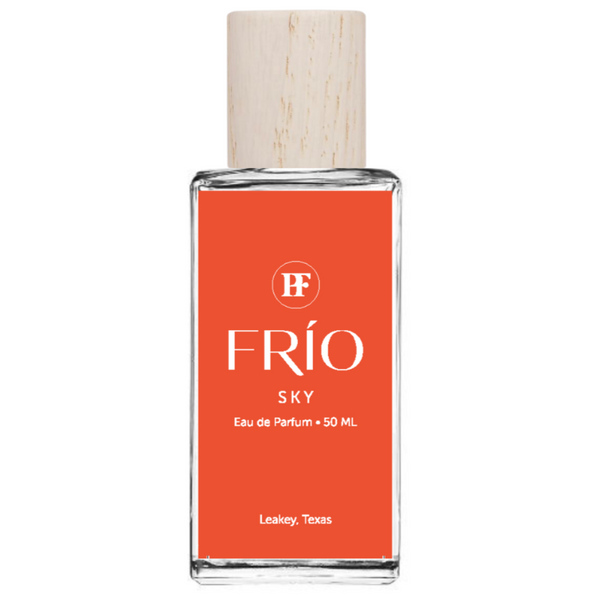 Perfume bottle with orange label and wooden cap on white background