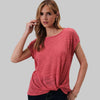 Woman wearing a pink t-shirt against a plain background