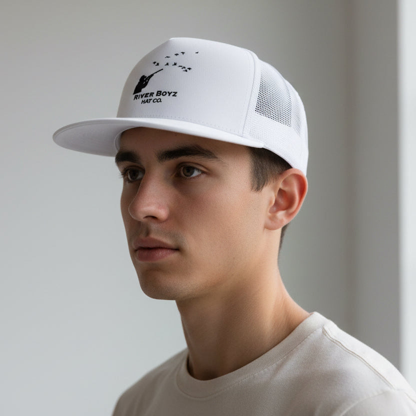 Man wearing a white cap with a logo against a neutral background