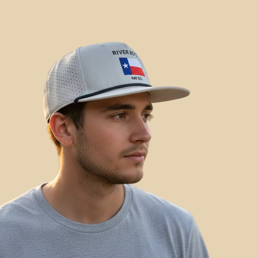 Man wearing a cap with a Texas flag design on a beige background