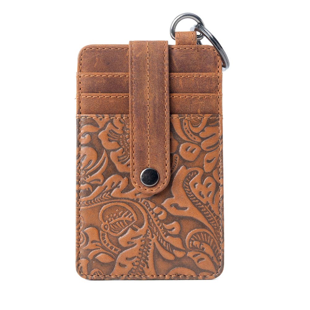 Brown leather card case with embossed design on a white background