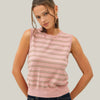 Woman wearing a pink striped sleeveless top against a white background