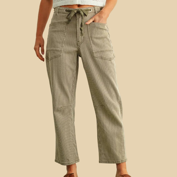 Person wearing green striped pants with a white background