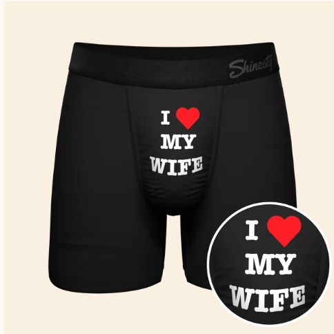 A Pair of black boxers with the words I love my wife on a cream background