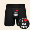 A Pair of black boxers with the words I love my wife on a cream background