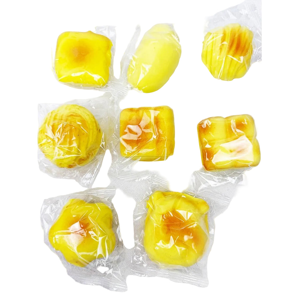 Yellow pastries in clear plastic packaging on a white background