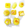 Yellow pastries in clear plastic packaging on a white background