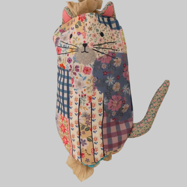 Patchwork cat-shaped pillow on grey background