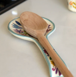 Wooden spoon on a colorful plate with a blurred background