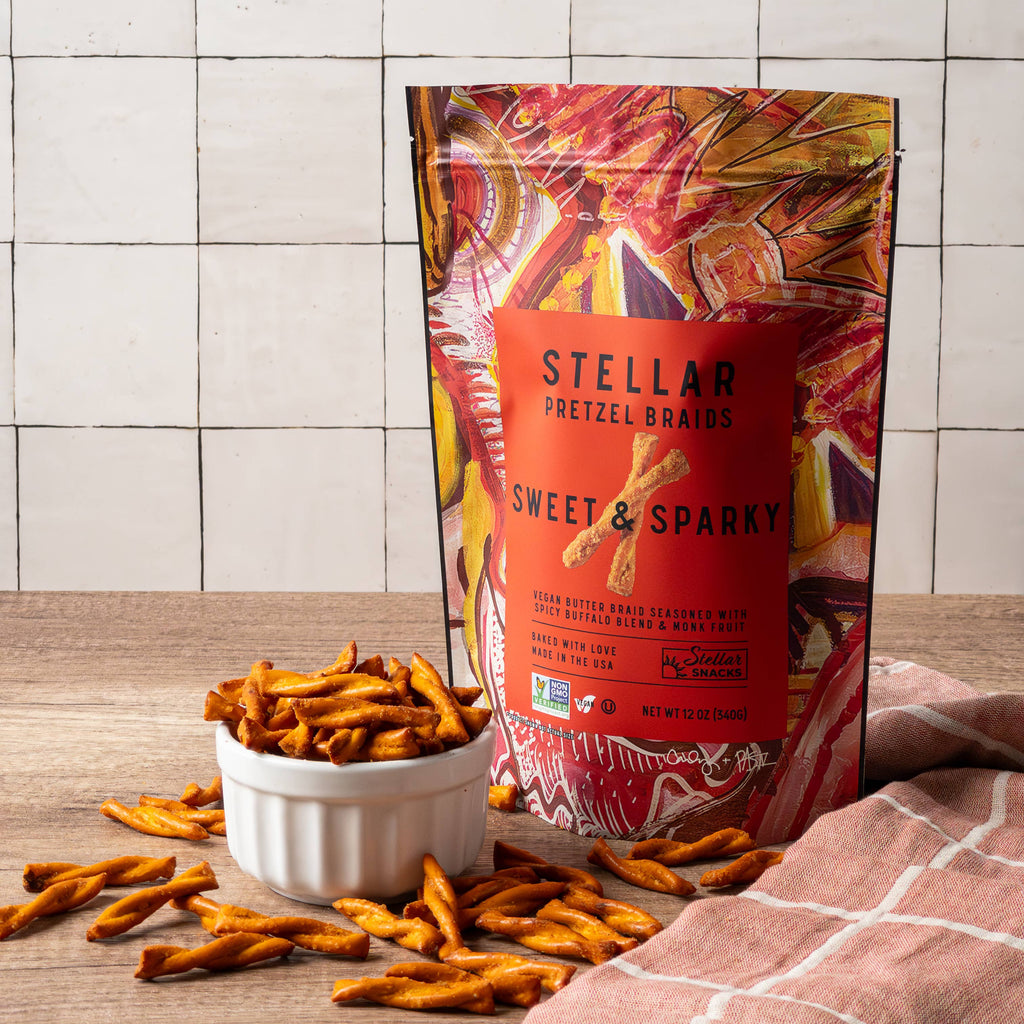 Stellar pretzel snacks with a colorful packaging on a wooden surface and tiled wall background