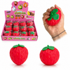 Strawberry-shaped stress ball with packaging and a hand squeezing it.