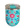 Floral-patterned tumbler with a turquoise lid on a wooden surface