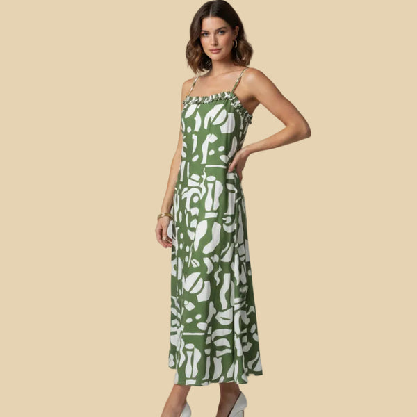 Woman wearing a green and white patterned dress on a beige background