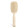 Beige paddle hair brush on a white background