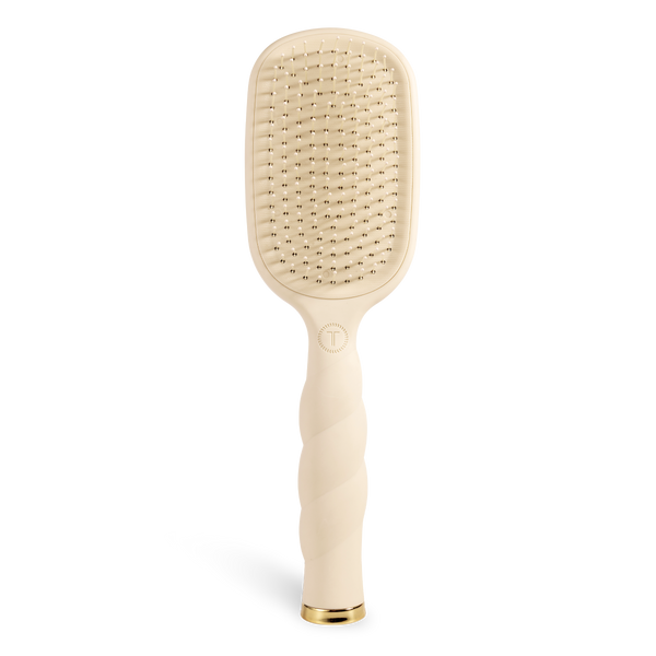 Beige paddle hair brush on a white background