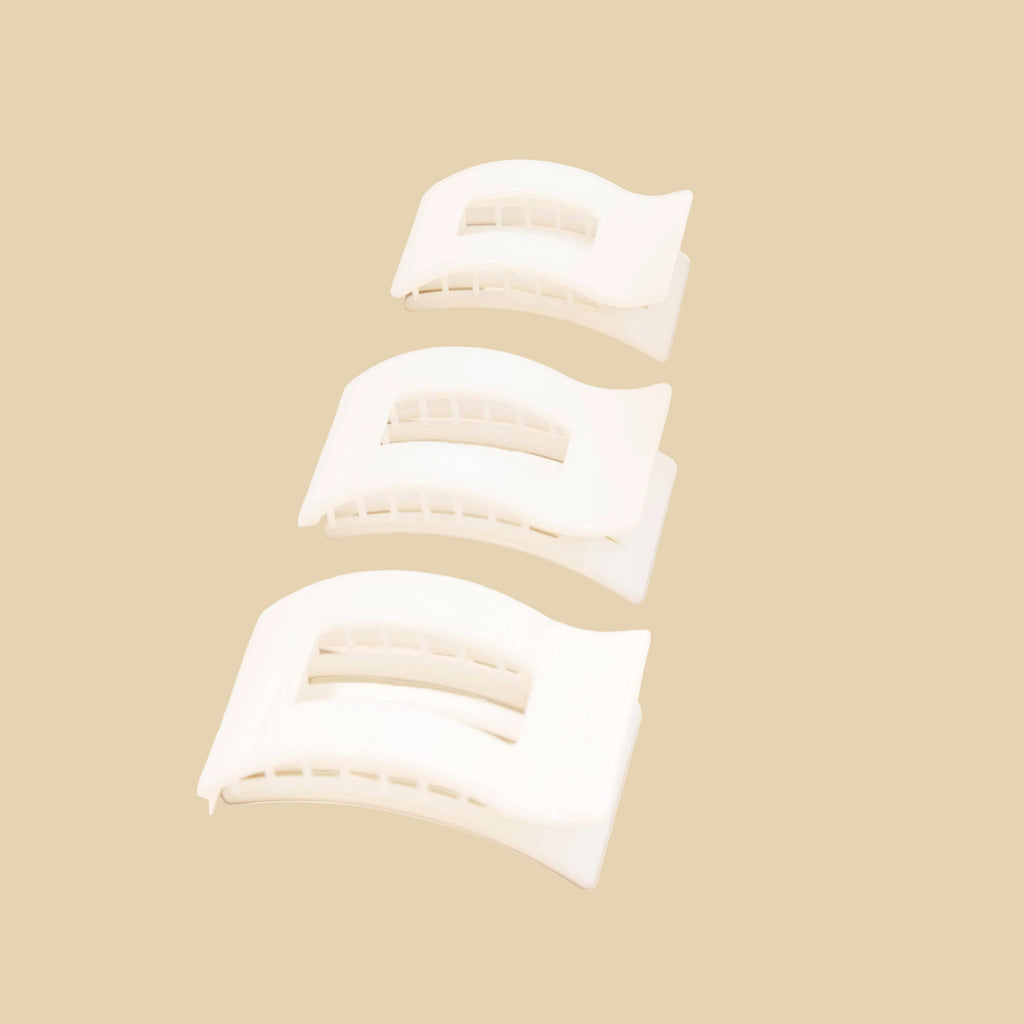 Three white rectangular objects on a beige background
