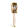 Hairbrush with gold bristle head and white handle on a white background