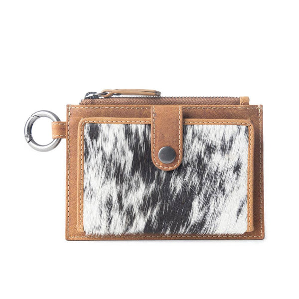 Small wallet with cowhide pattern and brown leather trim on a white background