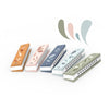 Set of five colorful harmonicas with leaf designs on a white background