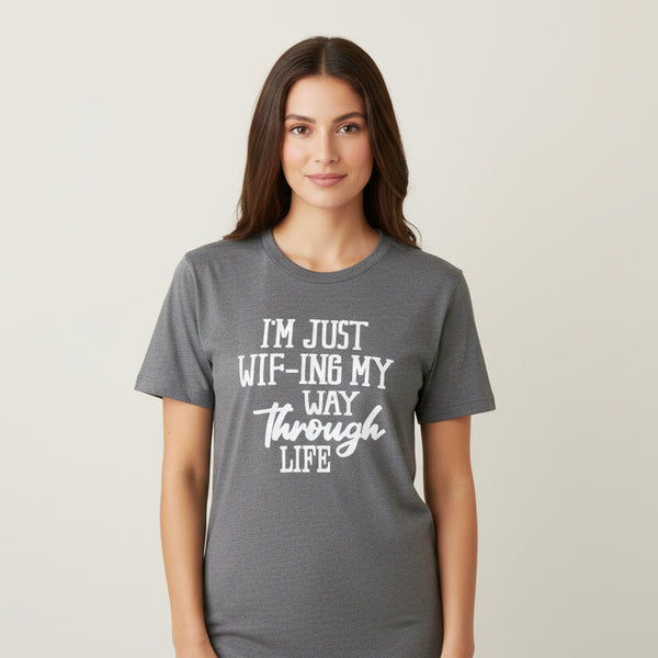 Gray t-shirt with humorous text design on a hanger.
