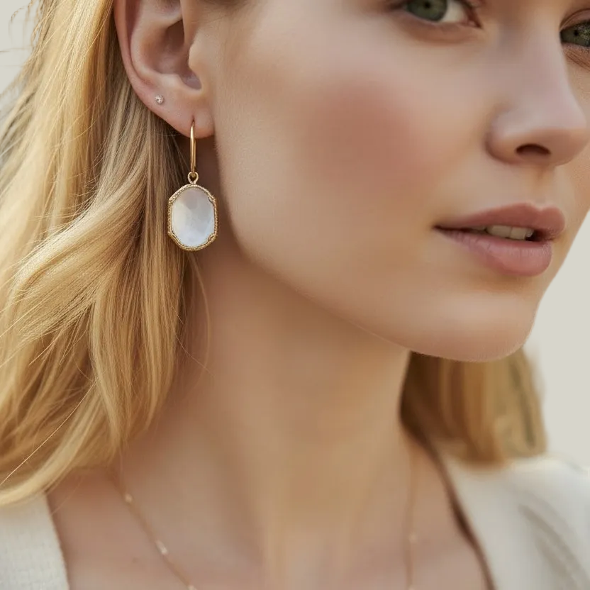 Close-up of a woman wearing a gold necklace and earrings with a blurred background