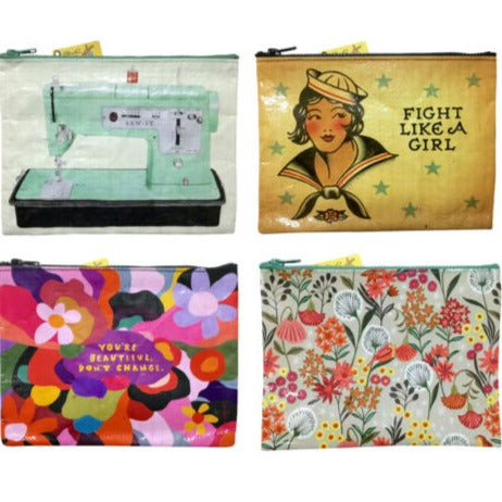 A collection of four Blue Q zipper pouches with various designs, including text, a floral pattern, and illustrations.