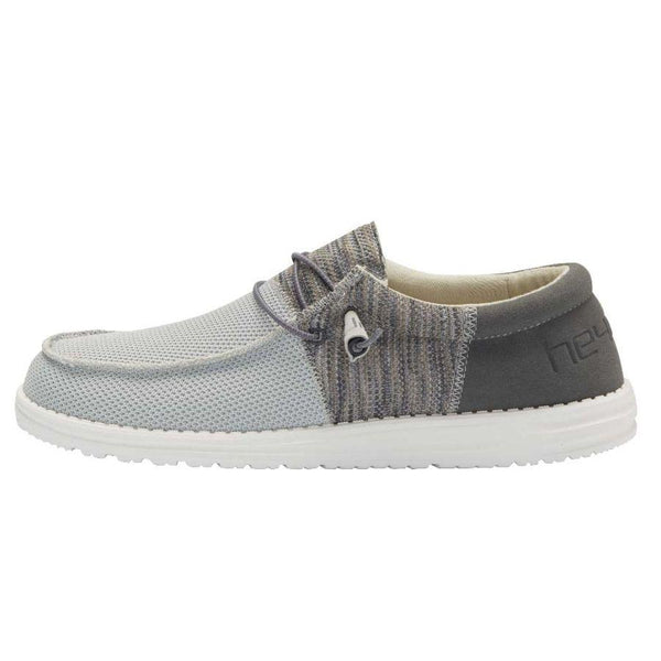 Gray and white shoe with a brand logo on a white background