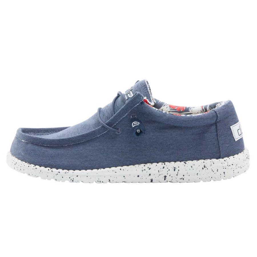 Blue casual shoe with speckled sole on a white background