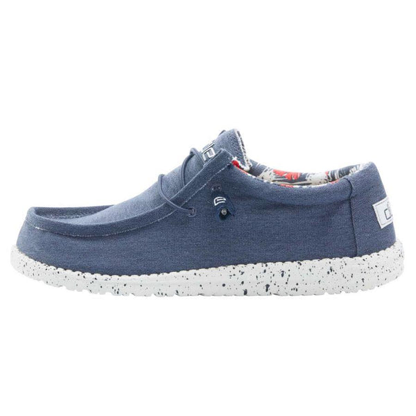 Blue casual shoe with speckled sole on a white background