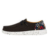 Sneaker with black polka dot pattern and floral side panel on a white background