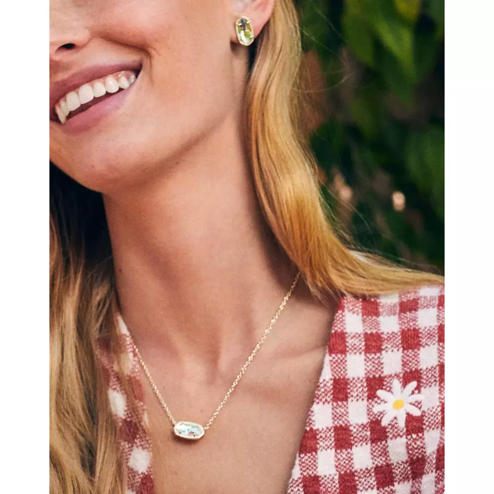 woman in red checked top wearring gold earring